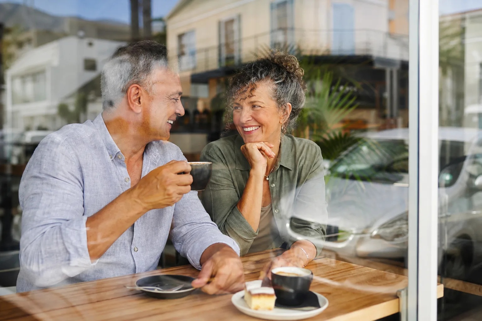 Mature couple chatting over coffee in a Dorset market town